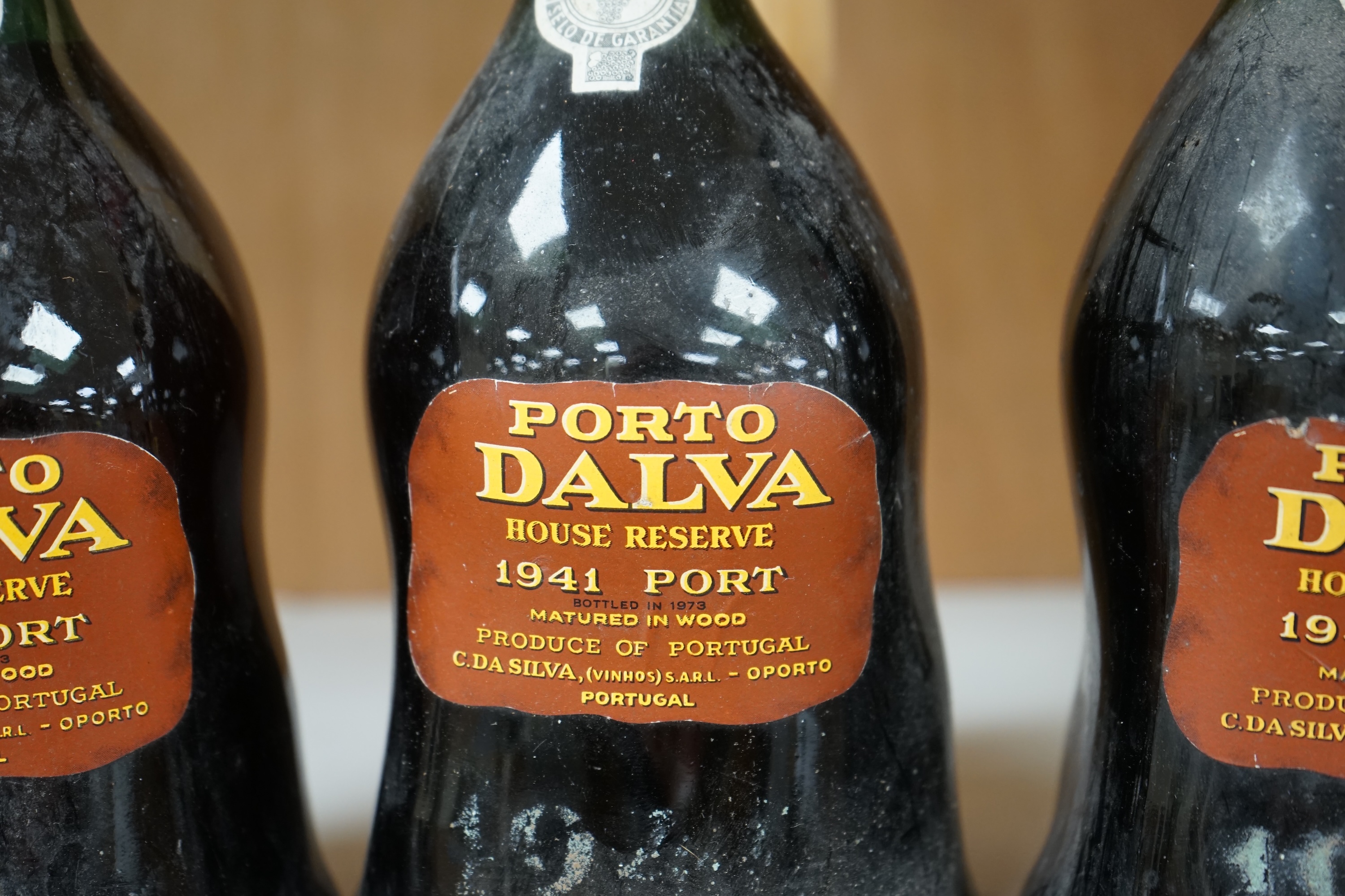 Three bottles of Porto Dalva house reserve port, comprising; 1934, 1940 and 1941. Condition - fair, some wear to labels and seals, etc.